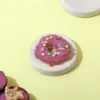 A Beautiful Purple Colour Sweet Wiggles N' Nibbles Donuts  on a cream colour table