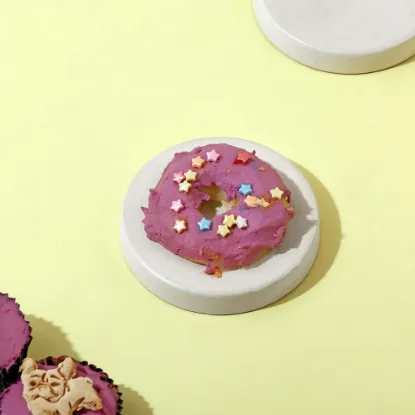 A Beautiful Purple Colour Sweet Wiggles N' Nibbles Donuts  on a cream colour table