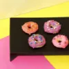 4 Different Colour Sweet Wiggles N' Nibbles Donuts on a table